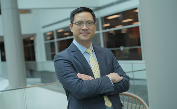 A confident businessman with his arms crossed and smiling