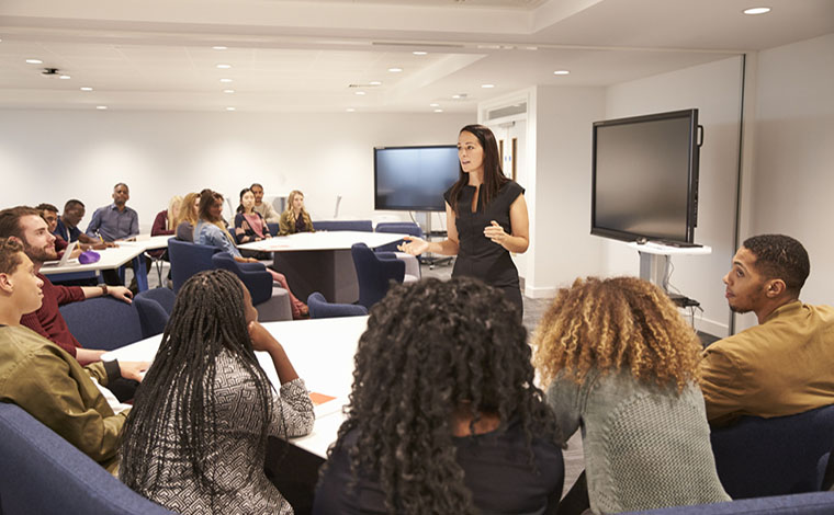 Female teacher addressing university students