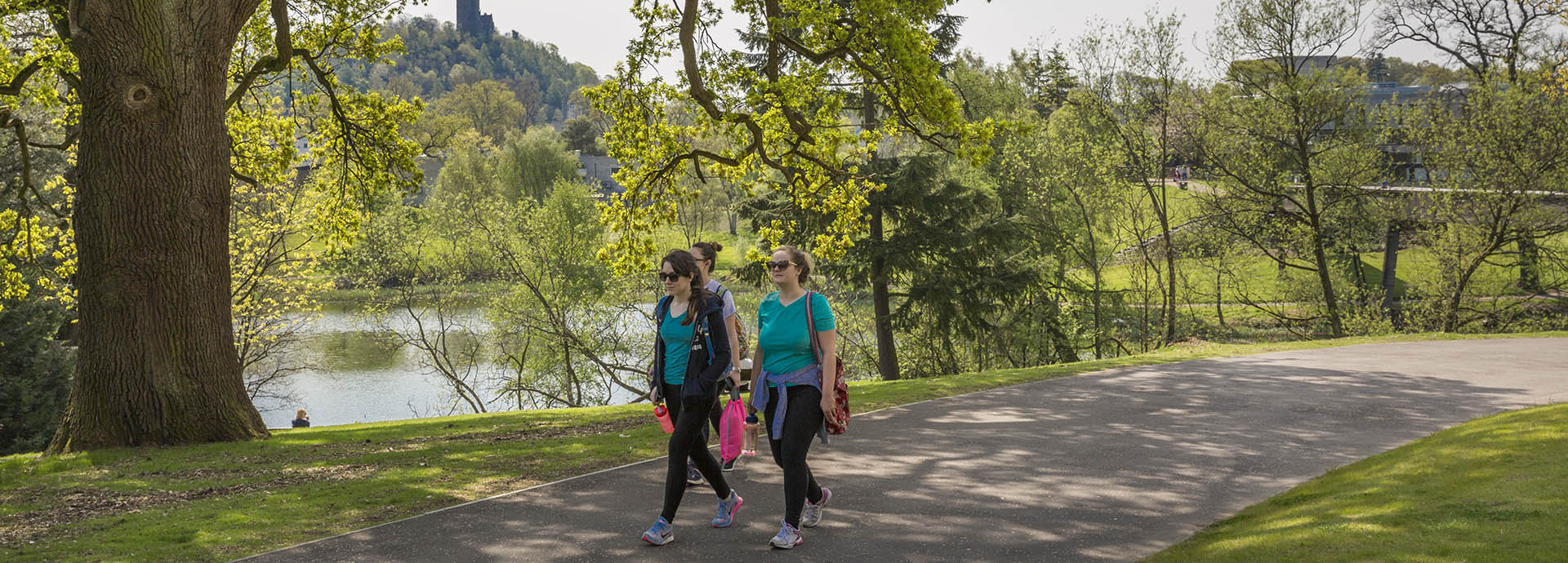 Students walking next to loch