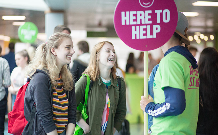 Students asking questions at open day event