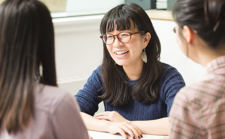 A student smiling and talking