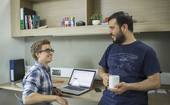 Two students in a room in student accommodation