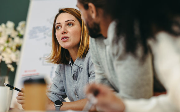 A woman in conversation at a business meeting