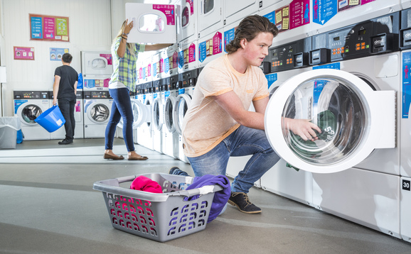 Student doing laundry at student accommodation