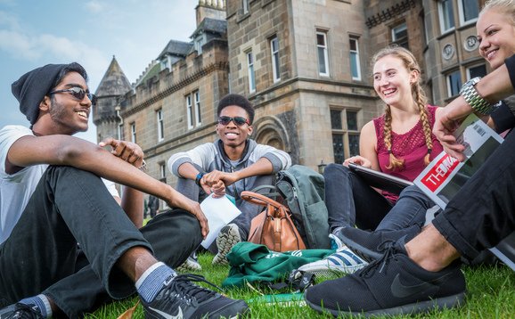 Group of students sitting outside Airthrey Castle 578x358