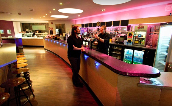 A student ordering drinks at the bar