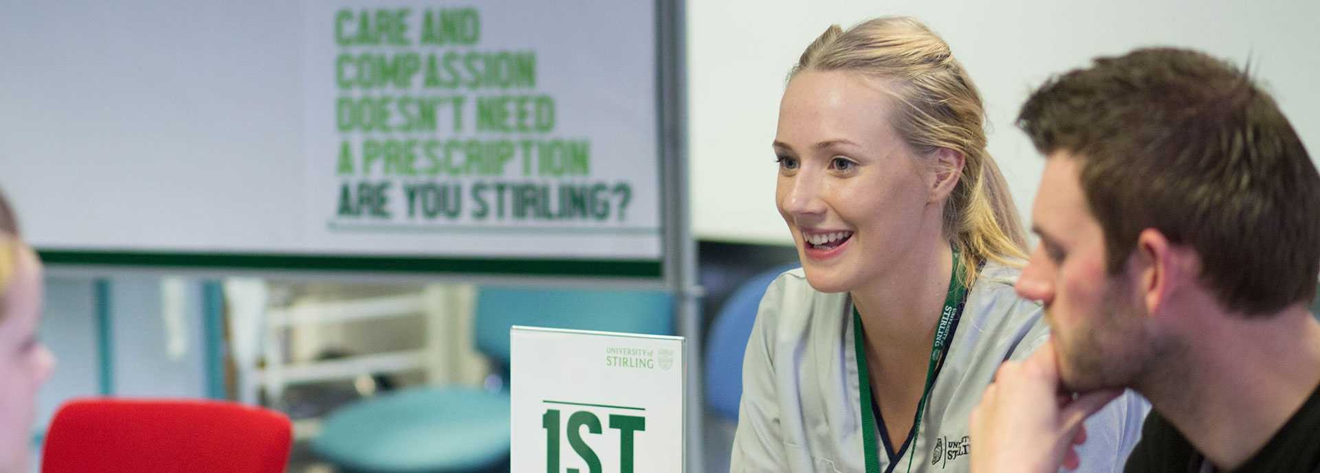 Image of undergraduate students talking to someone at an open day