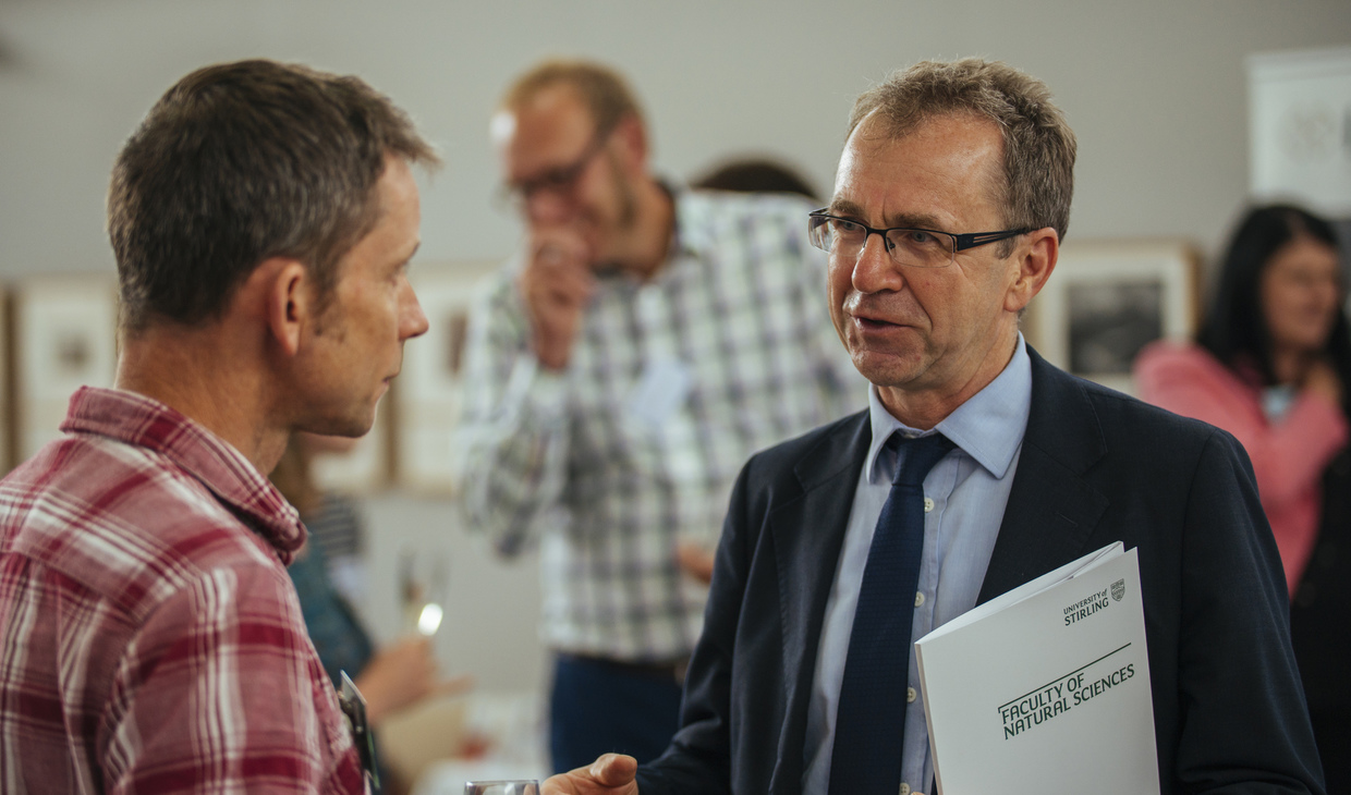 Student and businessman talking at a networking event