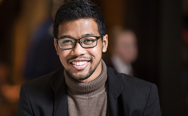 Male international student wearing black jacket. 