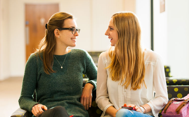 Two students talking and laughing