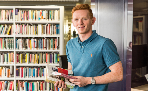 student in library