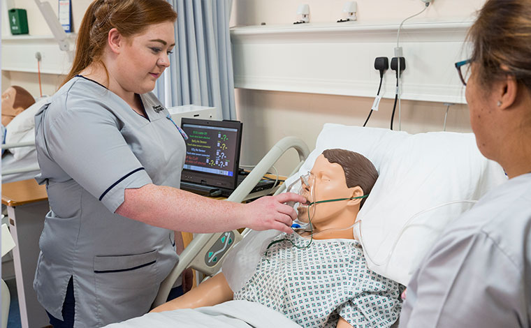 Nursing students training with equipment