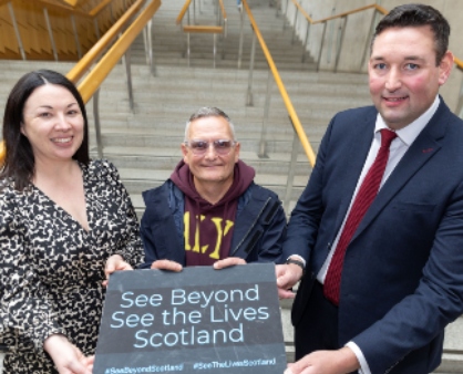 three people holding notice