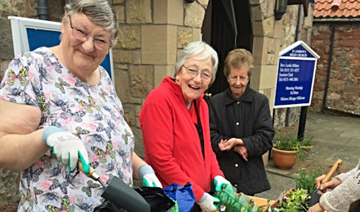 three women outside a church