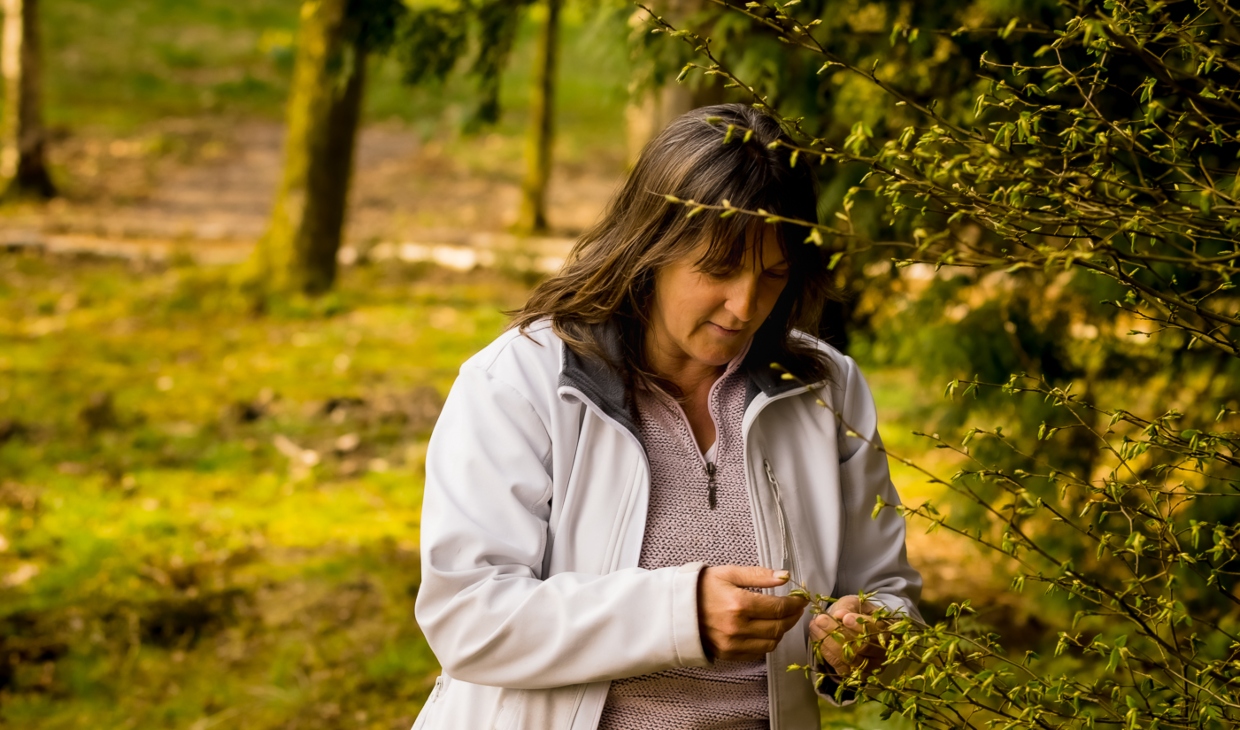 Woman looking at tree outside