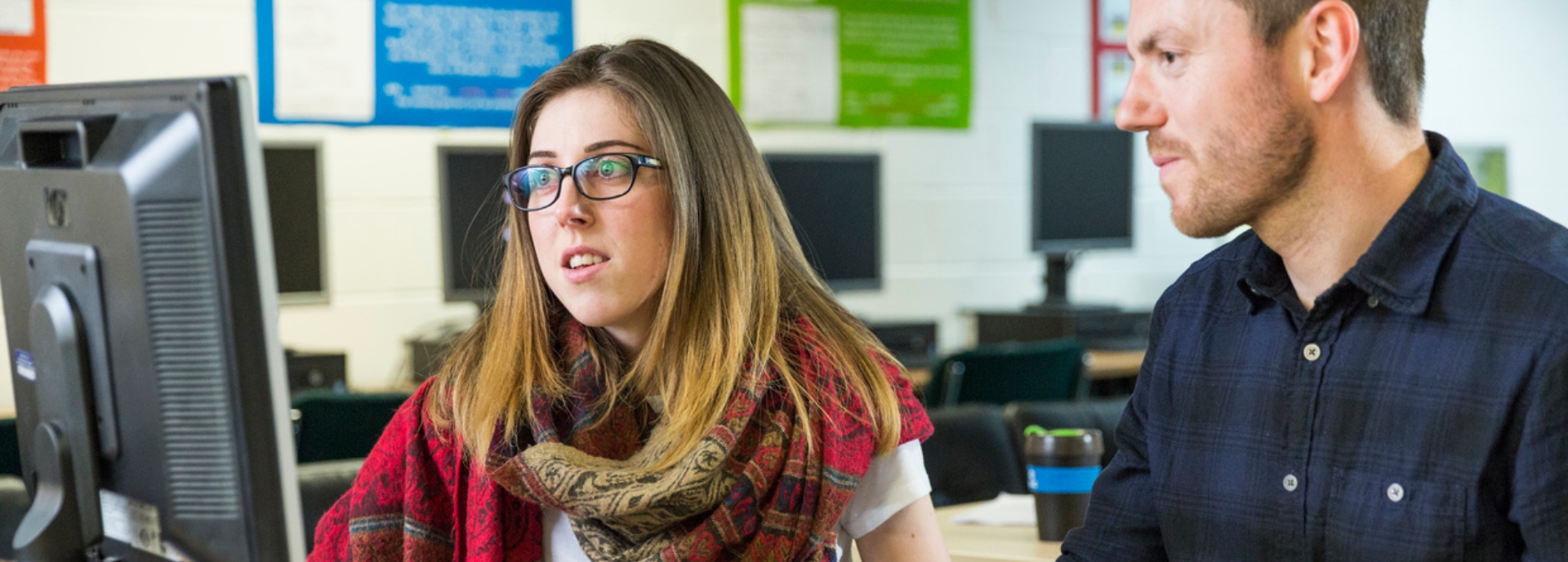 A student and researcher sitting at computer