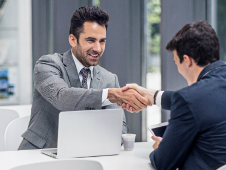 An image of 2 men shaking hands