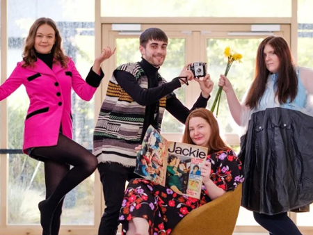 Students pose with items from the 1960s