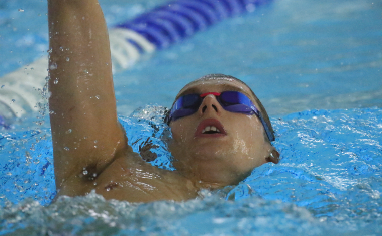 Duncan Scott swimming backstroke in water