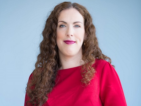 Head and shoulders shot of woman in red top