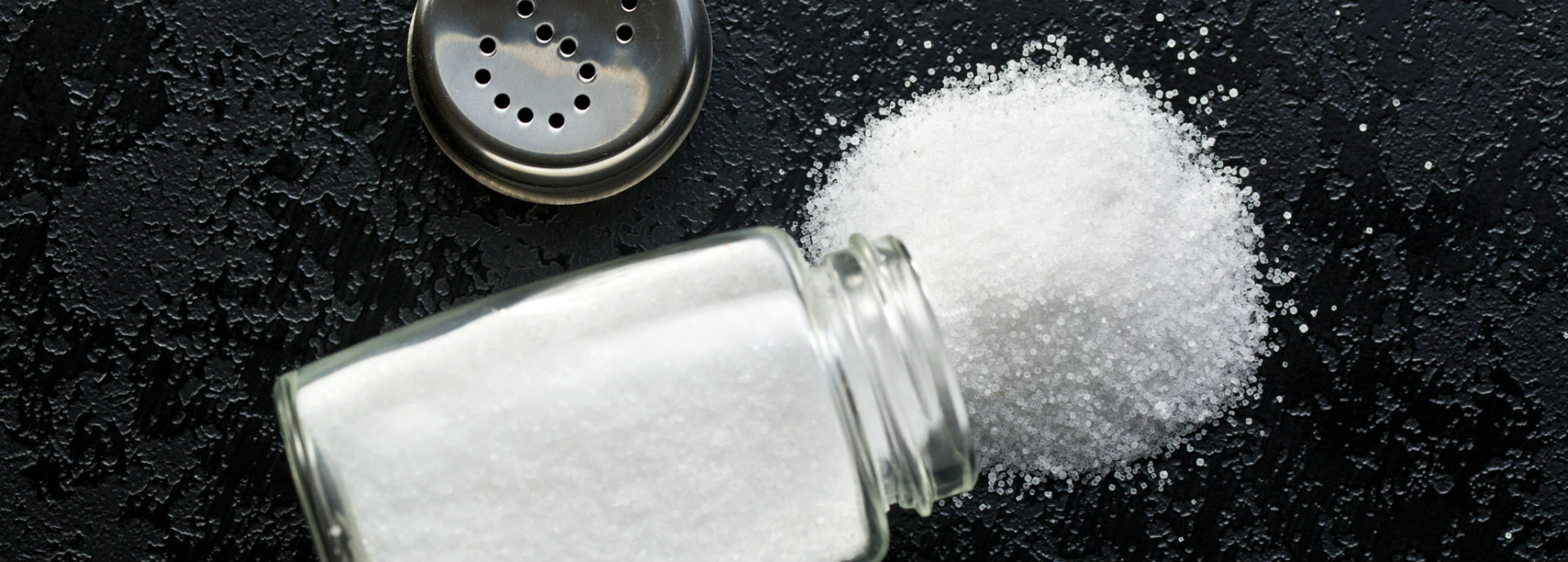 Salt spilling from an overturned salt cellar