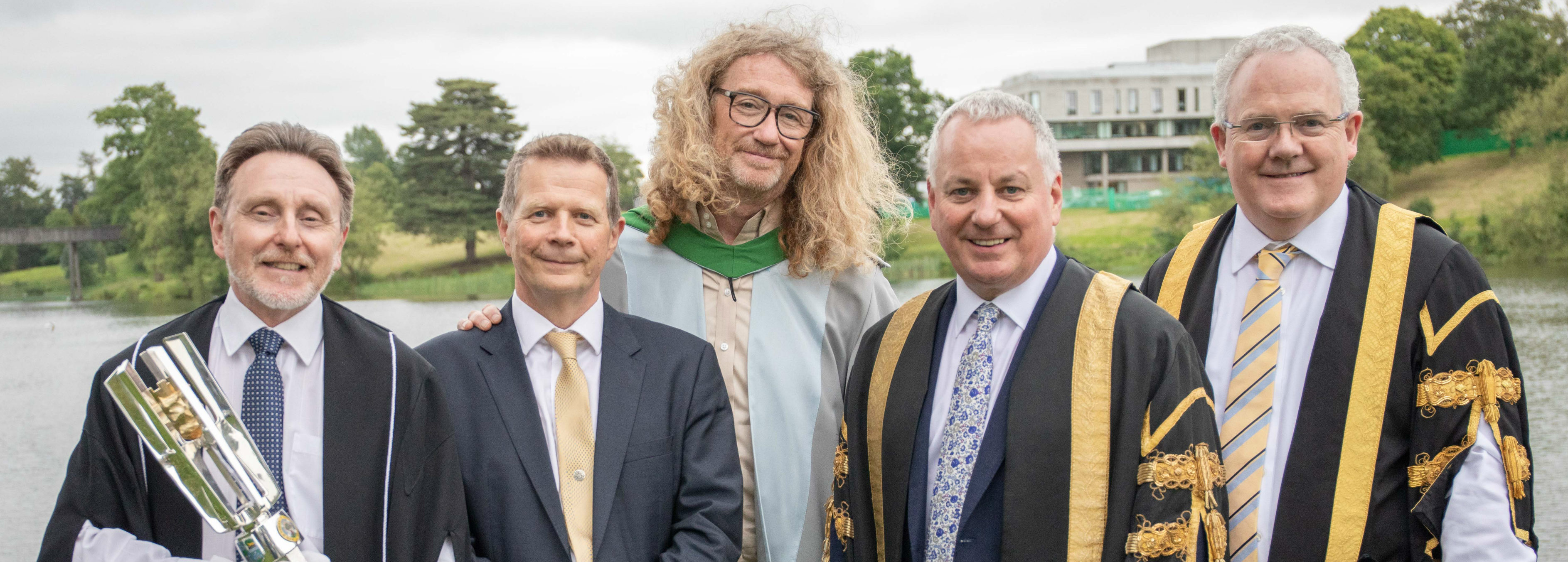 Honorary graduates wearing gowns