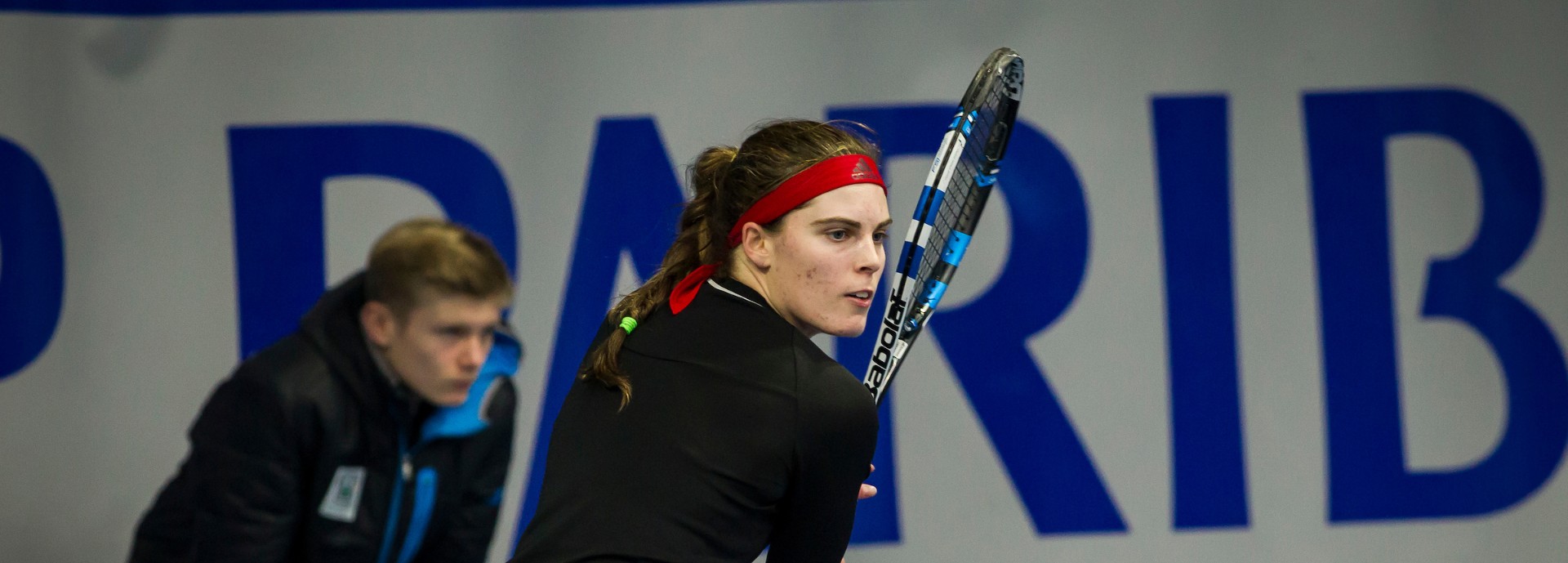 Tennis player, Maia Lumsden, hitting backhand shot