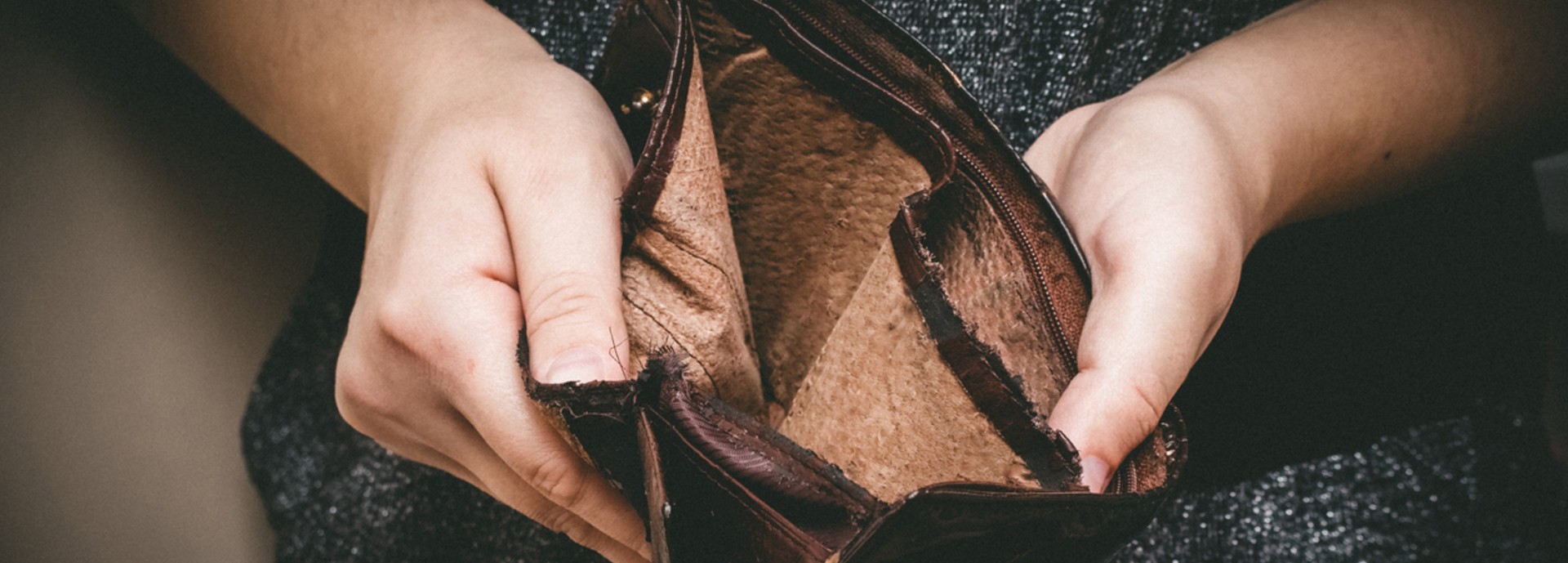 A woman holding an empty wallet