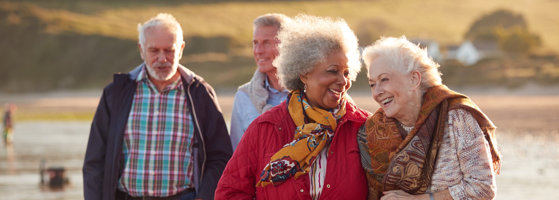 A group of older adults enjoying a work at the beach.