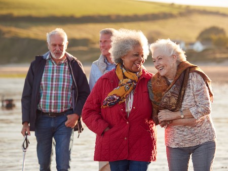 A group of older adults enjoying a work at the beach.