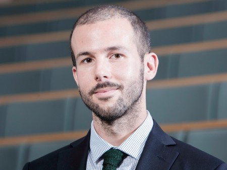 Dr Guido Noto La Diega. Head and shoulders photo of a man with very short dark hair, stubble and moustache wearing a shirt, tie and suit jacket looking directly to camera.