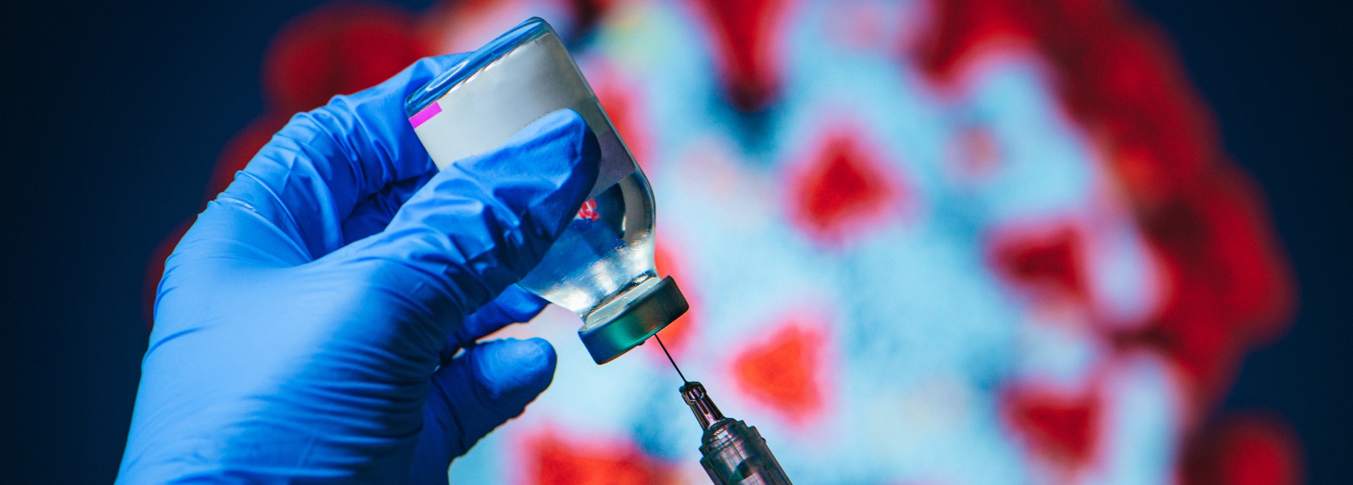 Medical practitioner prepares a COVID-19 vaccine.