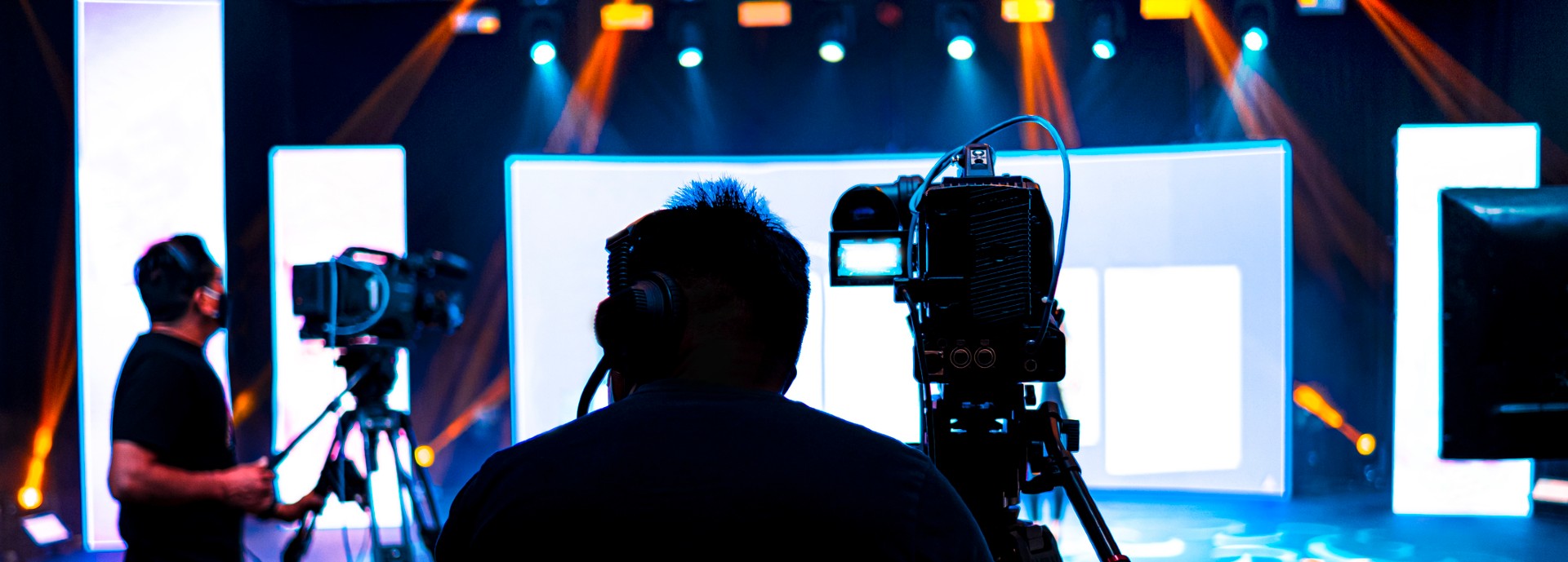 Professional cameraman - covering on event with a video, cameraman silhouette on live studio news, Selective focus