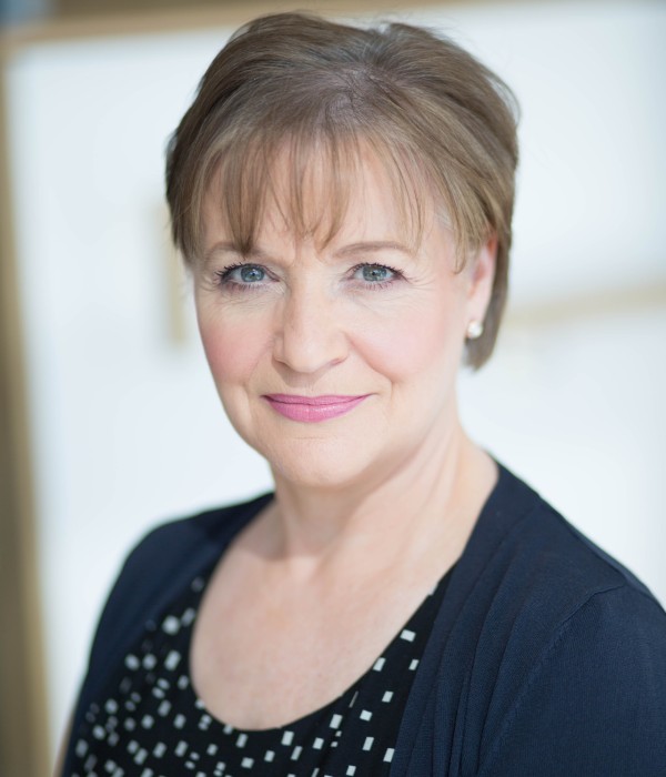 Elaine Douglas is a white woman with short brown hair and is photographed facing straight to camera.