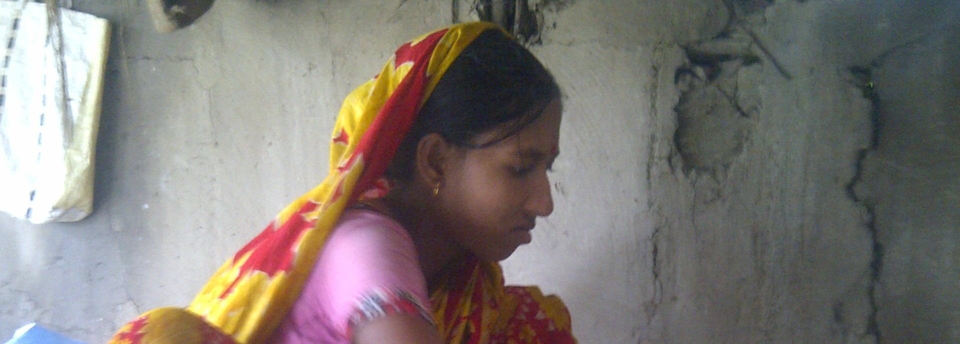 Woman in Bangladesh cooking tilapias