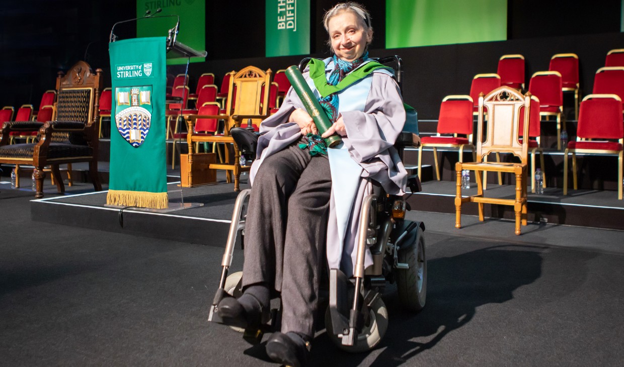 Sally Witcher photographed on stage in graduation robes