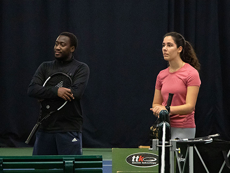 Students watch a demonstration during a Just Play Beginner Tennis session