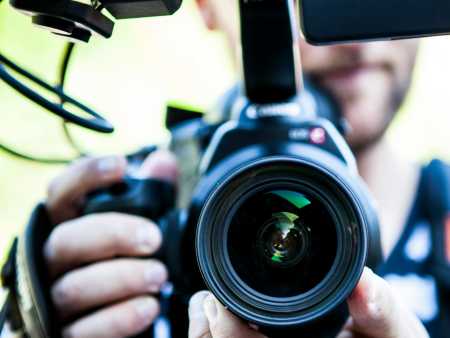 A close up photo of a person holding a film camera