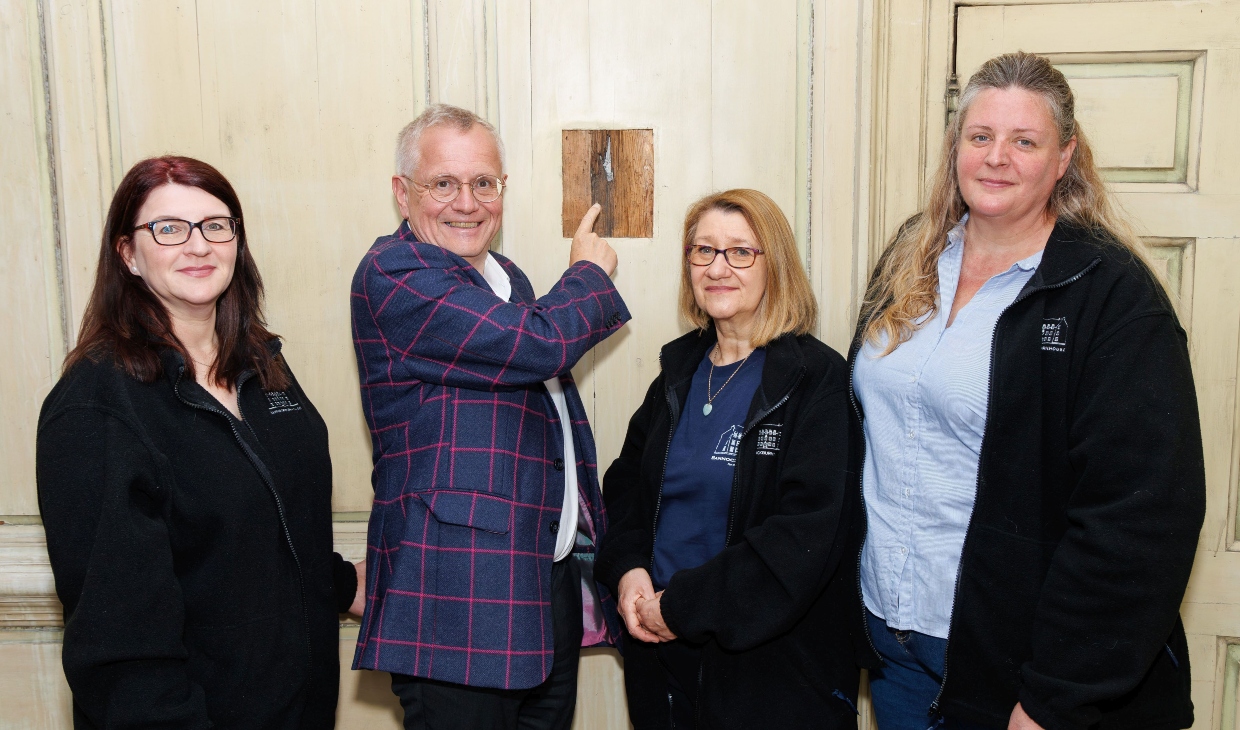 Bannockburn House team stand next to the musket hole.