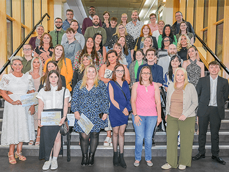 Stirling students standing together with their course completion certificates