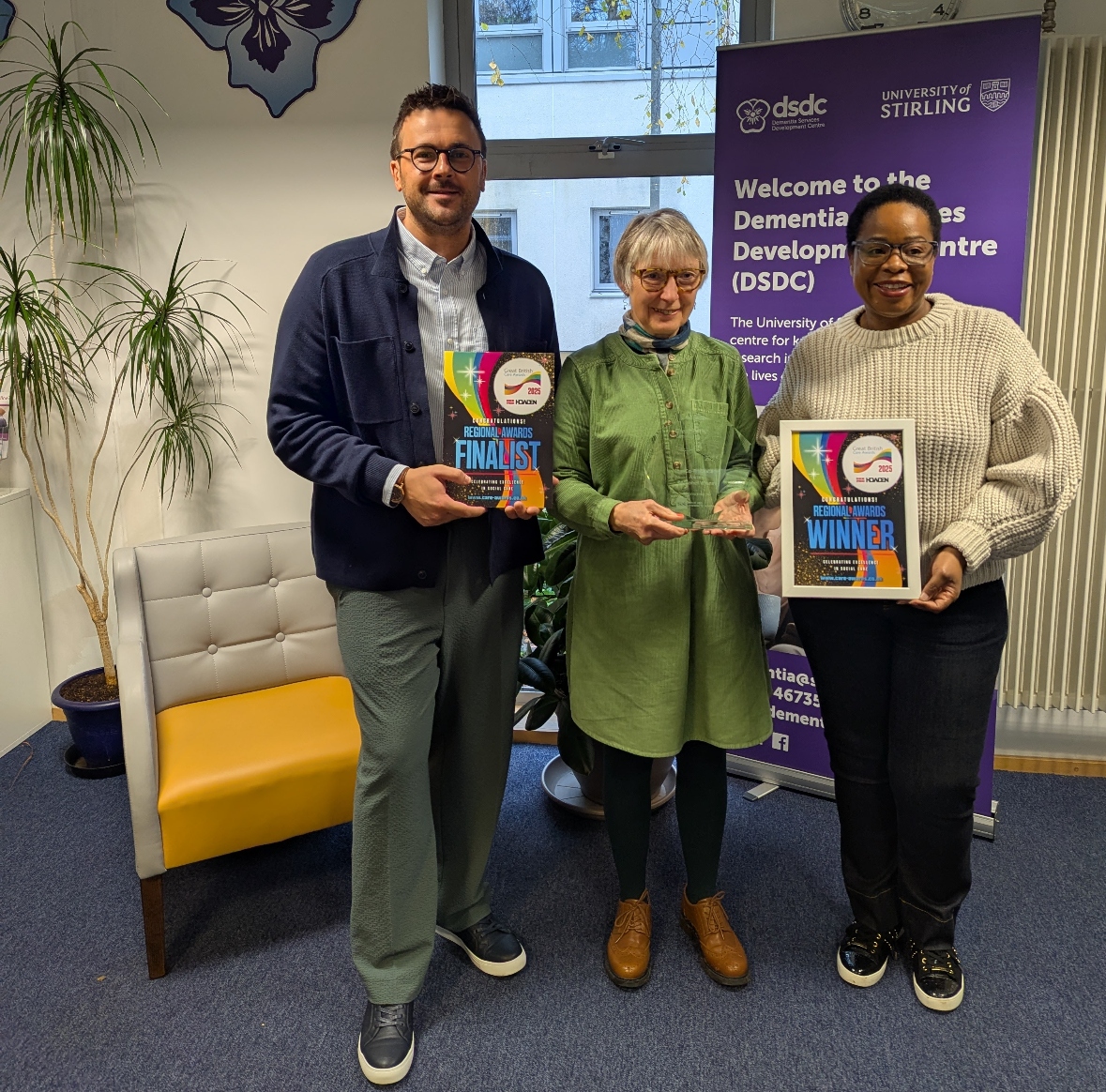 a man and two women holding awards