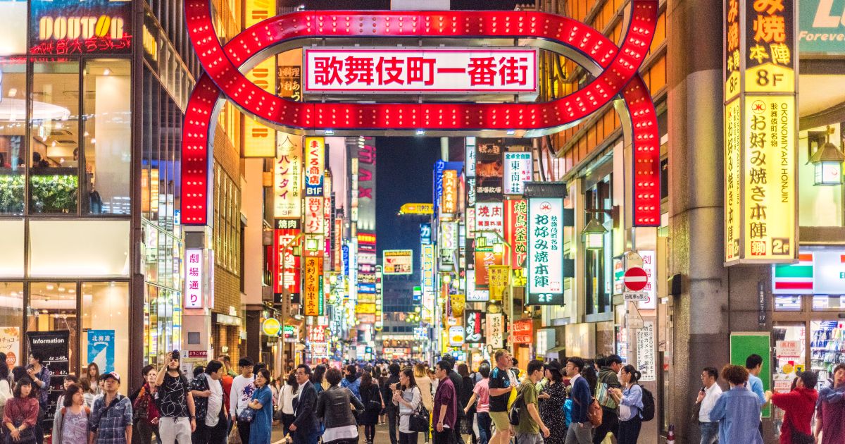 Tokyo with bright neon signs and a busy pedestrian crossing