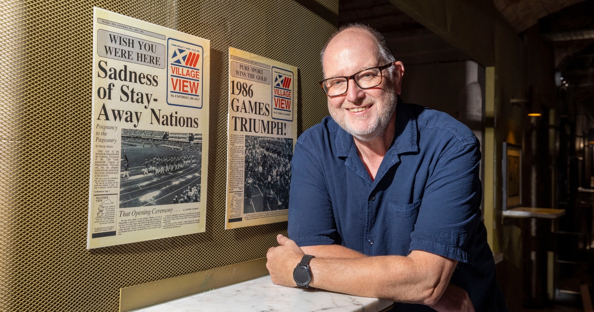 Richard Haynes pictured alongside the Village View newspaper.