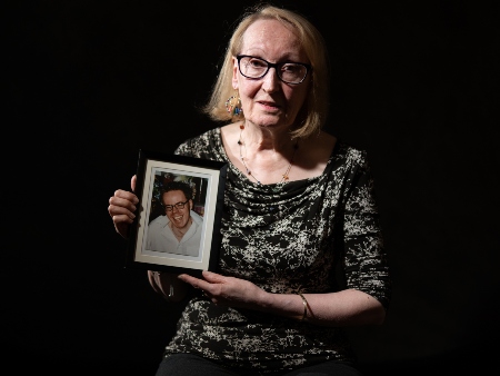 A woman sitting with a photograph