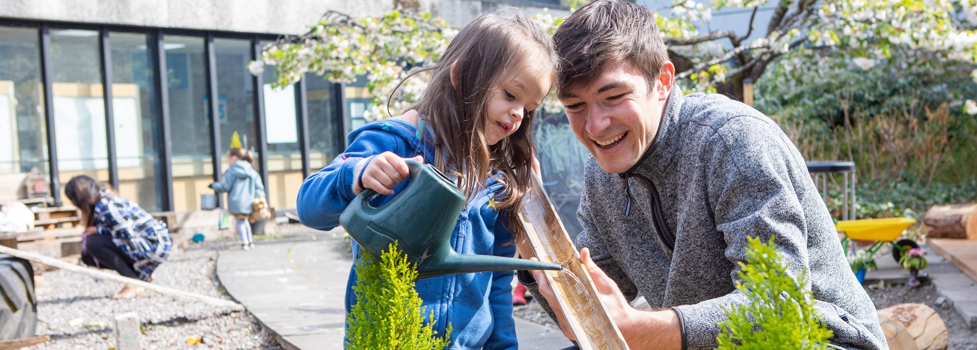 Child and staff member playing in Psychology Kindergarten garden