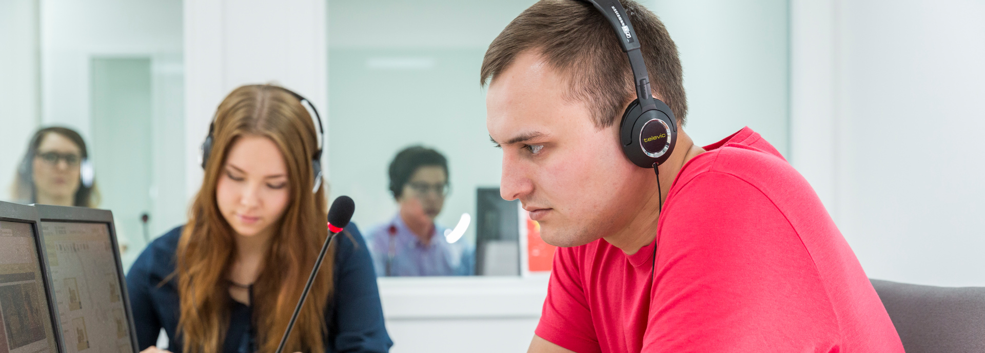 male student studying at computer with headphones