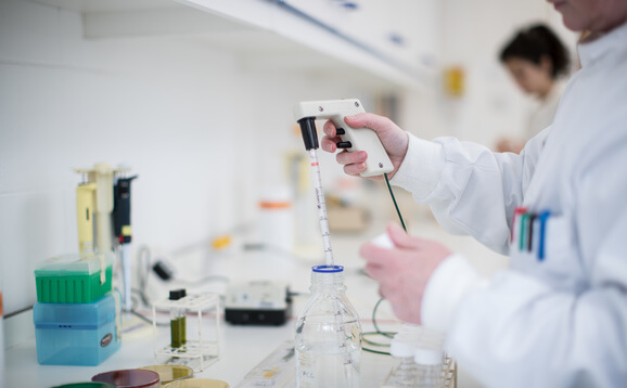 Worker in lab with aquaculture equipment