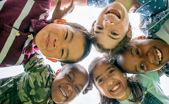 Five children looking and smiling into camera