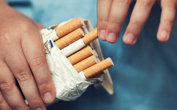 person holding cigarette pack