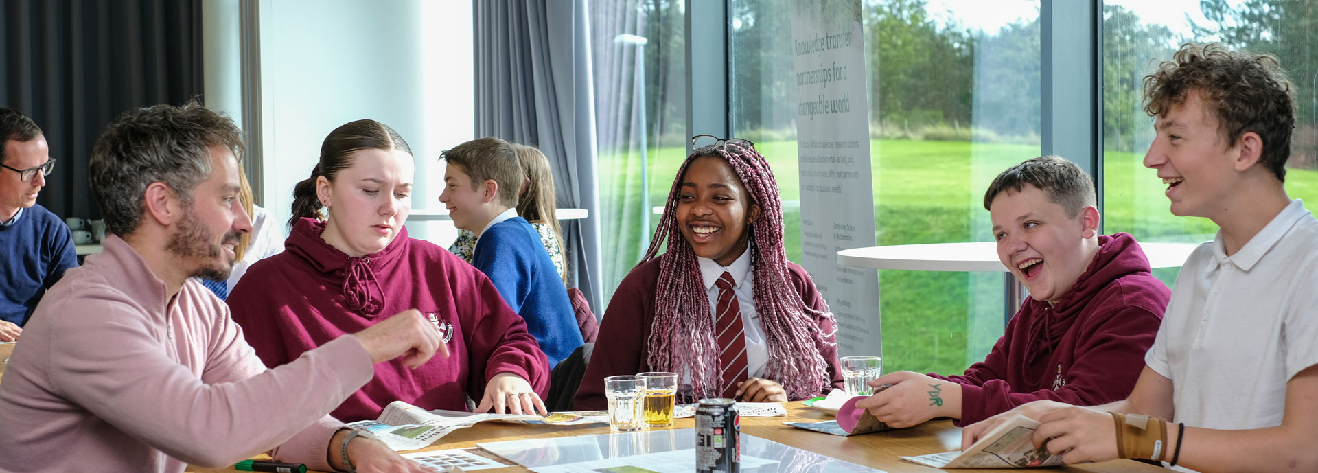 School children sat around a table with mentors